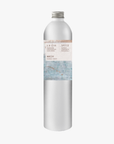 A tall, slender aluminium bottle of spicey Hand & Body Wash sustainable refill. Label featuring Emma Cassi artwork.