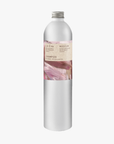 A tall, slender aluminium bottle of Roseum Shampoo sustainable refill. Label featuring Meinke Flessemen artwork.