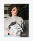 La Eva x Katie-Coston holding original artwork "anthos" for jasmina