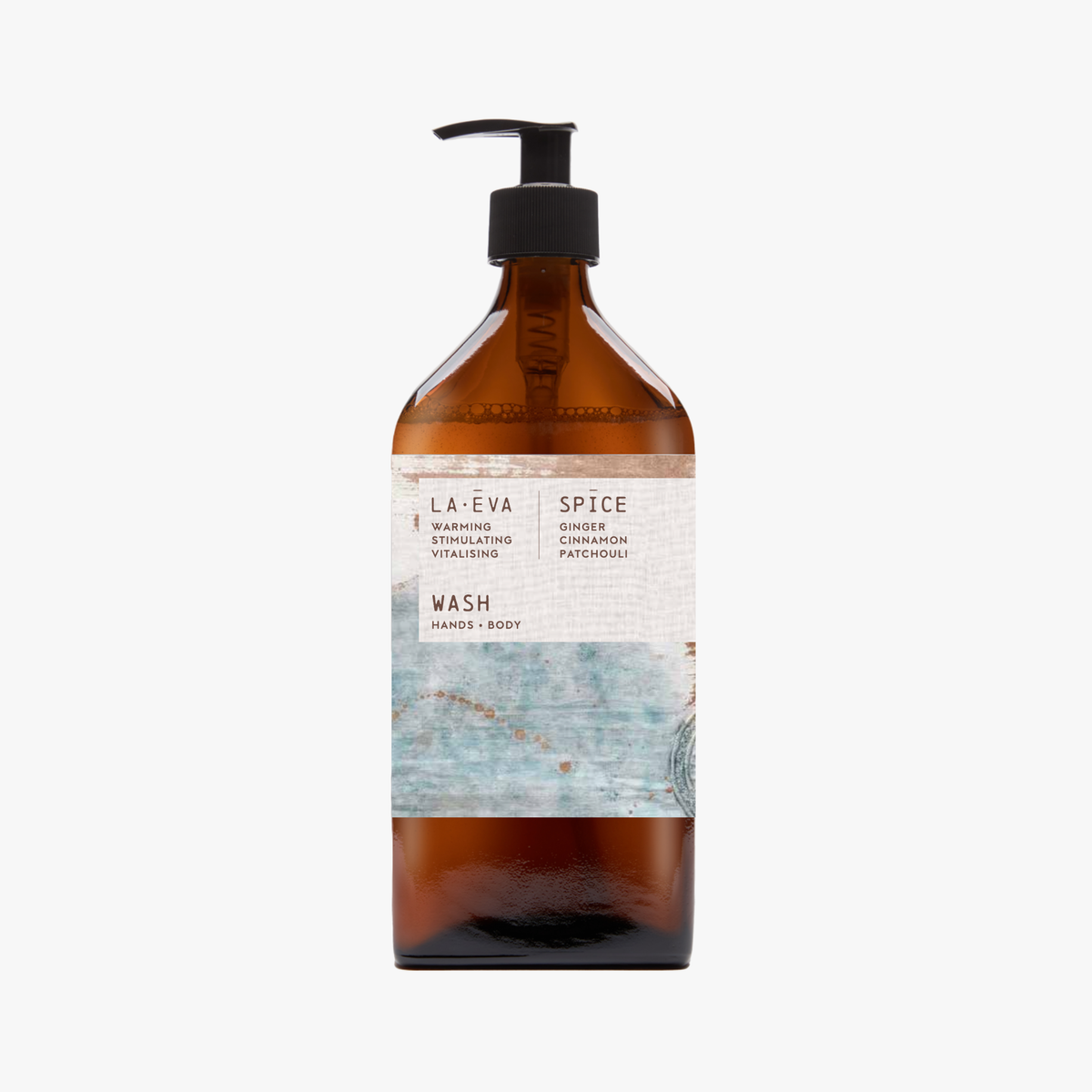 A recycled amber glass pump bottle of La-Eva Spice Hand & Body wash with a label featuring artwork by Emma Cassi,  Spicy wash; ginger, patchouli, cinnamon