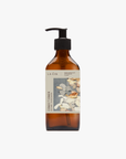 A recycled amber glass pump bottle of Roseum Conditioner with a label featuring 'Younger Together' artwork by Valeska Hykel and the text 'roséum ', part of the rose geranium botanical, Pelargonium roseum.