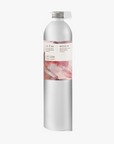 A tall, slender aluminium bottle of Roseum hand and body lotion sustainable refill. Label featuring Meinke Flessemen artwork.