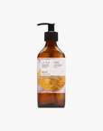 A recycled amber glass pump bottle of Phos Hand & Body Wash with a label featuring artwork by Emma Cassi, Phos; lemongrass, may chang and basil