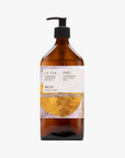 A recycled amber glass pump bottle of Phos Hand & Body Wash with a label featuring artwork by Emma Cassi, Phos; lemongrass, may chang and basil