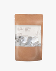 A package of La Eva Jasmina Exfoliant & Bath Salts with a label featuring artwork by Katie Coston