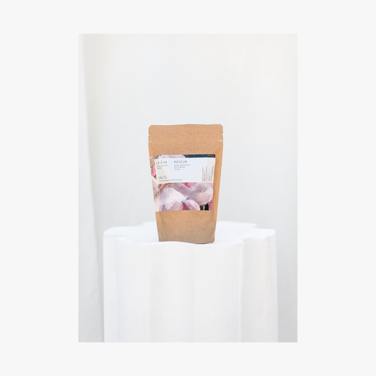 A package of La Eva Roseum Exfoliant & Bath Salts with a label featuring artwork by Meinke Flessemen