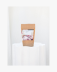 A package of La Eva Roseum Exfoliant & Bath Salts with a label featuring artwork by Meinke Flessemen