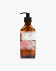 A pump bottle of Roseum Hand & Body Wash with a label featuring 'Flamingos' artwork by Meinke Flessemen and the text 'roséum' part of the rose geranium botanical, Pelargonium roseum.
