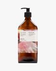 A pump bottle of Roseum Hand & Body Wash with a label featuring 'Flamingos' artwork by Meinke Flessemen and the text 'roséum' part of the rose geranium botanical, Pelargonium roseum.