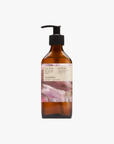 A pump bottle of Roseum Shampoo with a label featuring 'Flamingos' artwork by Meinke Flessemen and the text 'roséum' part of the rose geranium botanical, Pelargonium roseum.